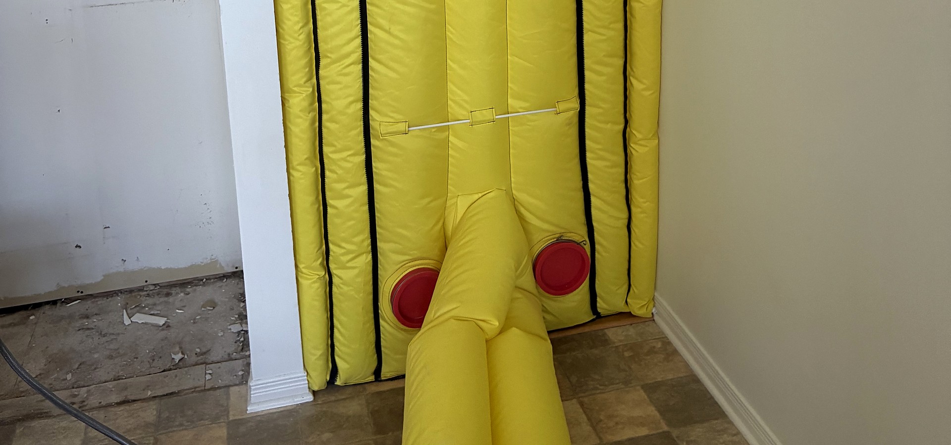 Air wall containment and negative-air duct set up on a job